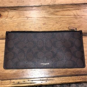 Brown and black Coach wallet/clutch